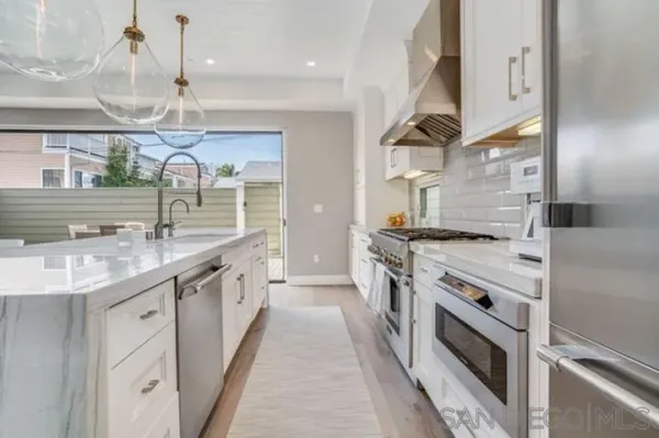 a kitchen with stainless steel appliances granite countertop a stove and a sink