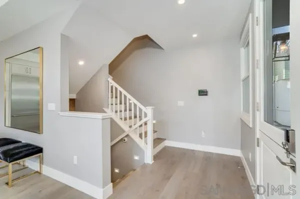 a view of entryway and hall with wooden floor