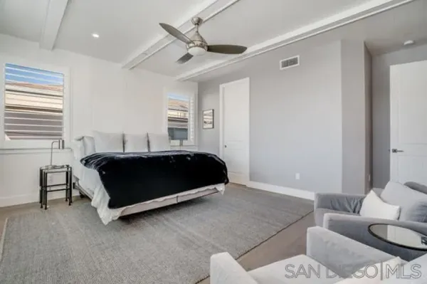 a bedroom with a bed and a ceiling fan