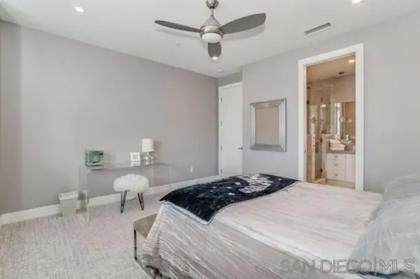 a bedroom with a bed and glass window