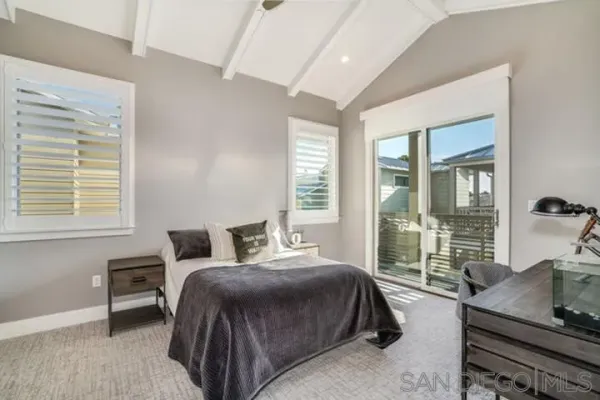 a view of a house with a balcony and large windows