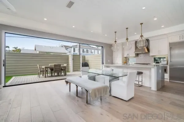 a kitchen with stainless steel appliances kitchen island granite countertop a table and chairs