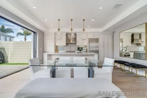 a large white kitchen with a large window