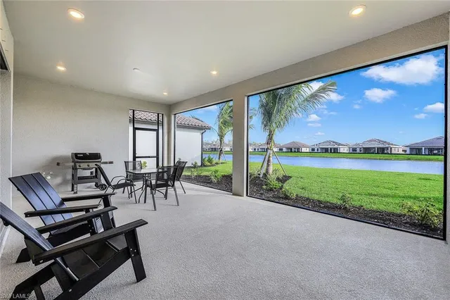 a view of a patio with a table & chairs