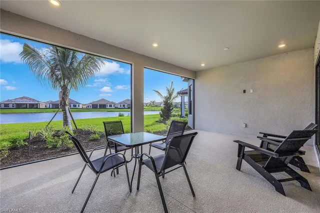 a view of a patio with a table and chairs under an umbrella with wooden floor
