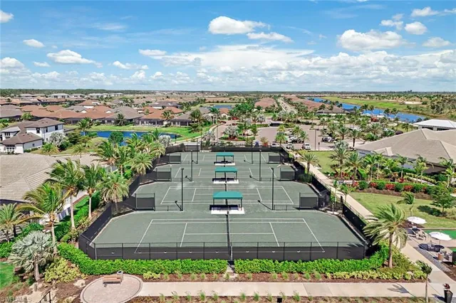 a view of swimming pool with outdoor seating and lake view