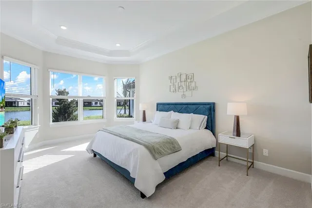 a large bed sitting in a bedroom next to a window