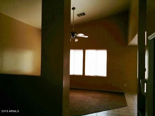 a kitchen with granite countertop a refrigerator a stove top oven and a granite counter tops