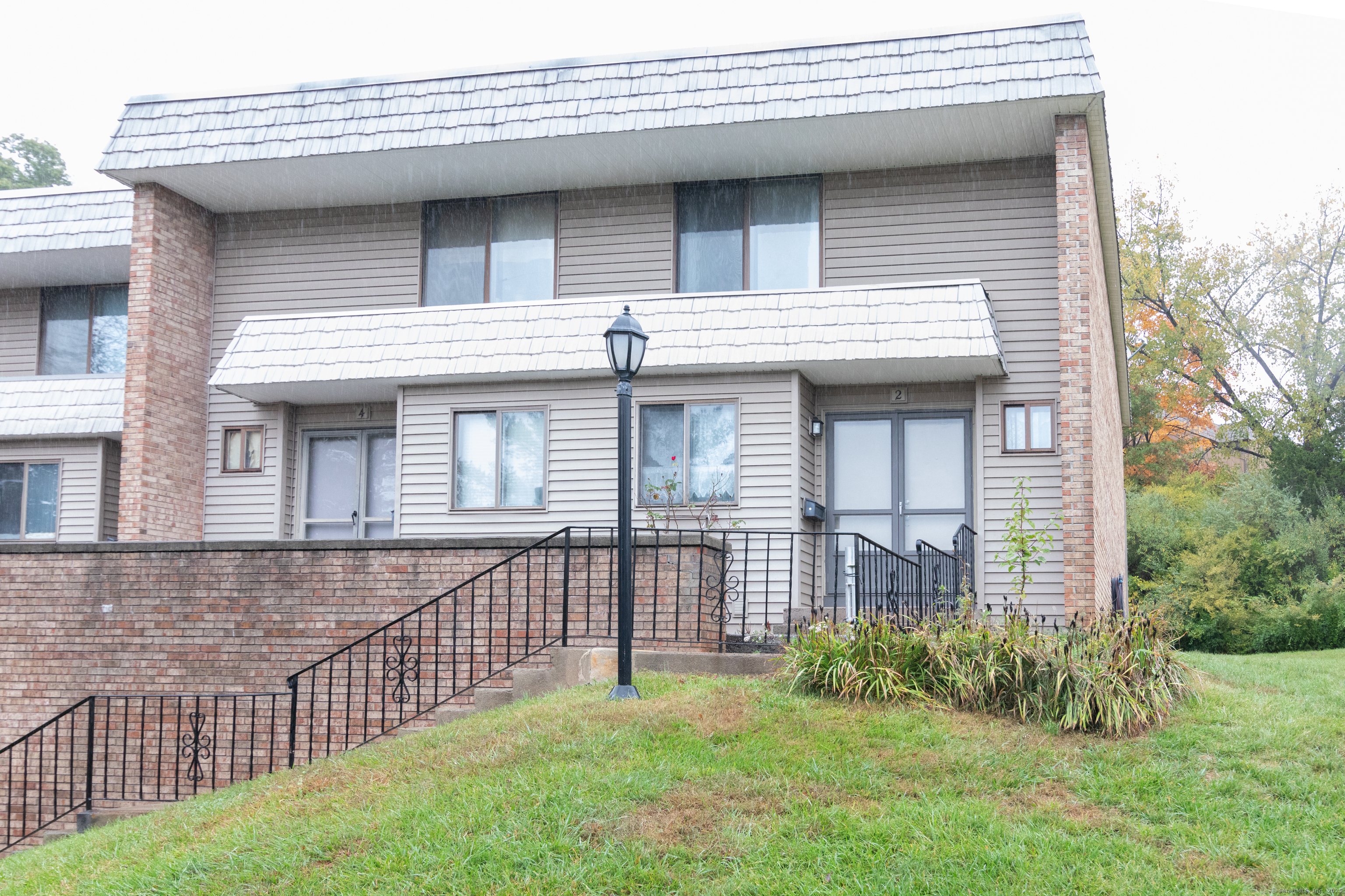 a view of a house with brick walls