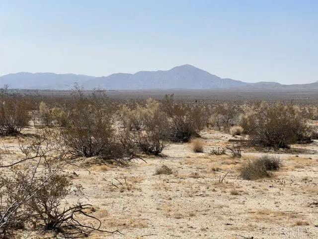 a view of a town with mountains in the background