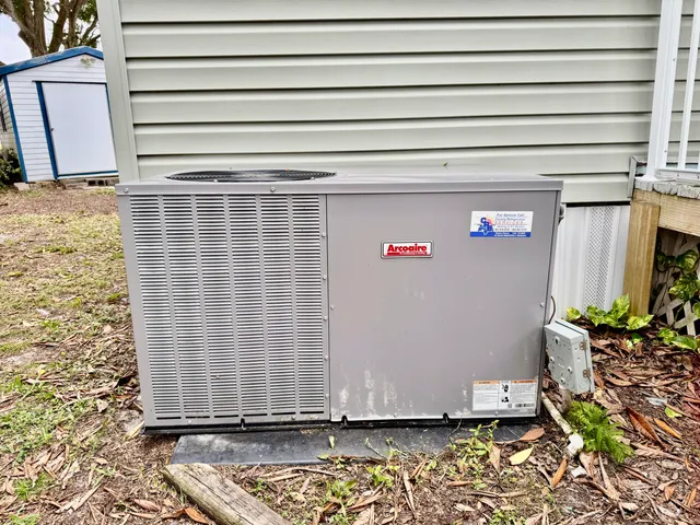 a view of a house with a yard and large tree