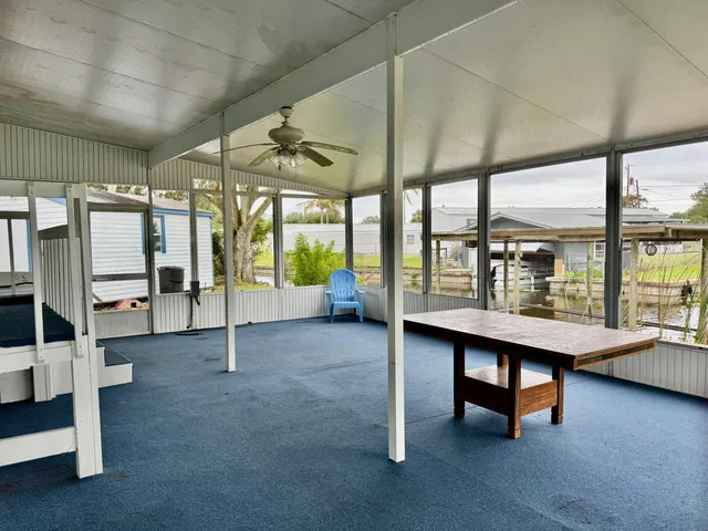 a view of a livingroom with furniture and a window