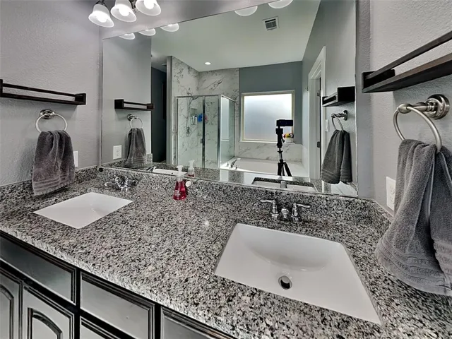 a bathroom with sink double vanity and a mirror