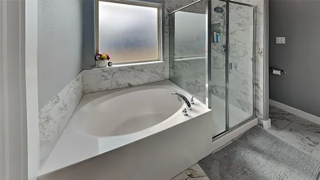 a bathroom with a bathtub and a shower