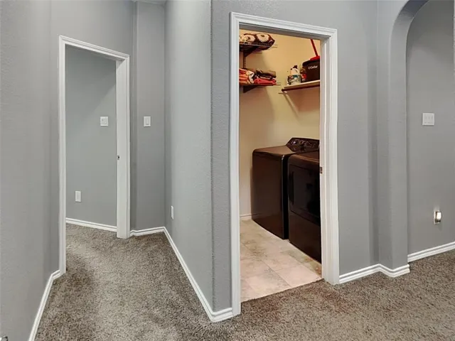wooden floor with a view of bedroom and hallway