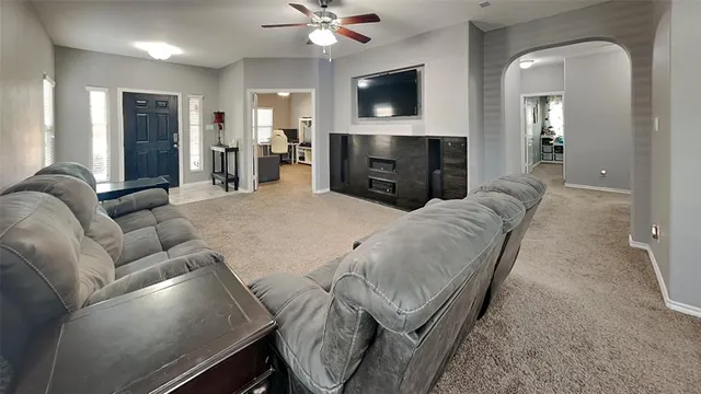 a living room with furniture fireplace and a flat screen tv