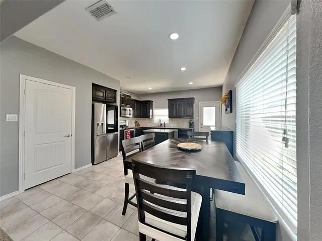 a view of kitchen with dining table and chairs