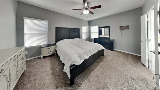 a spacious bedroom with a bed and a window