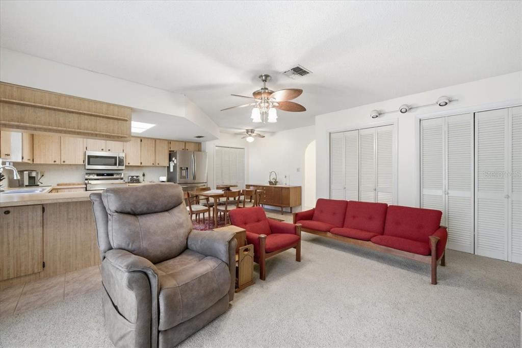 12439 Hanley Drive Spring Hill, FL 34608 - Photo 12 of 36 a living room with furniture kitchen view and a chandelier