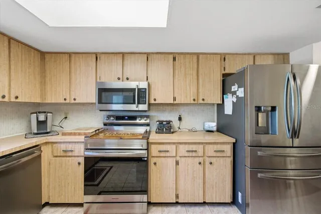 a kitchen with a refrigerator stove and microwave