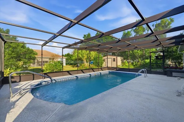 a view of a patio with a table and chairs under an umbrella