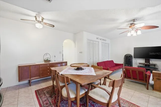a view of a dining room with furniture and a chandelier