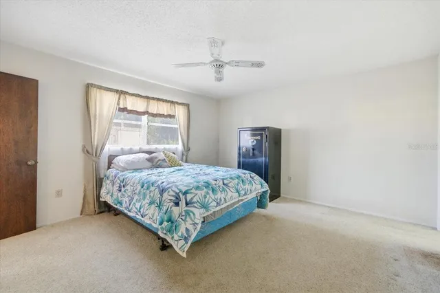 a bedroom with a bed lamp and window