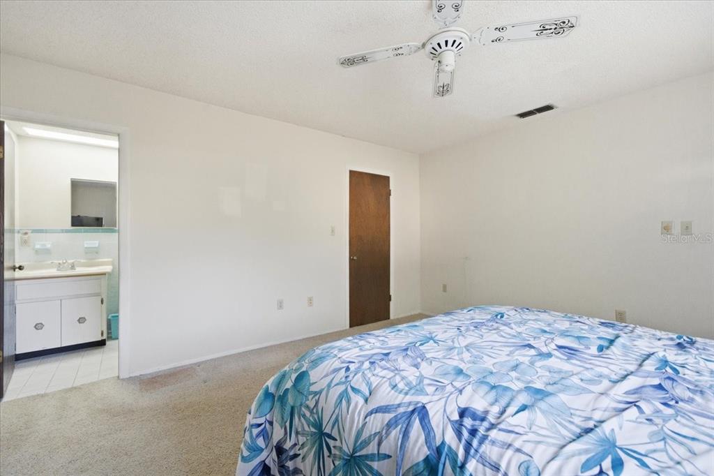 12439 Hanley Drive Spring Hill, FL 34608 - Photo 24 of 36 a bedroom with a bed and a cabinets