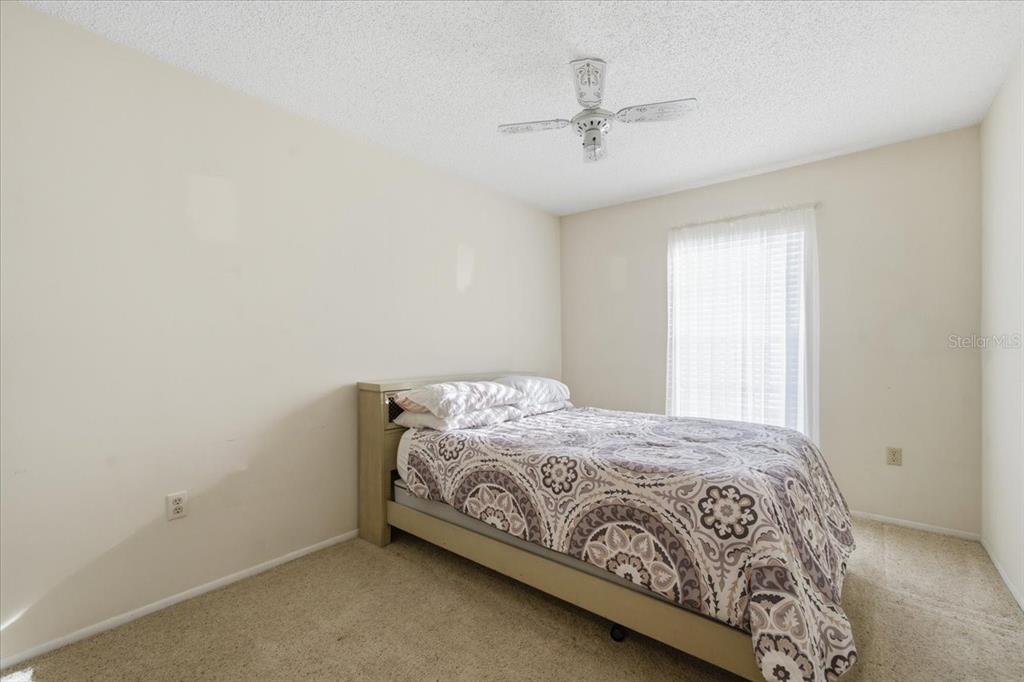 12439 Hanley Drive Spring Hill, FL 34608 - Photo 26 of 36 a bedroom with a bed and a window