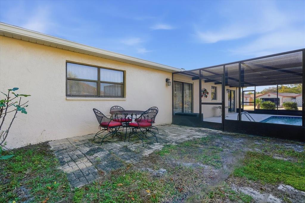 12439 Hanley Drive Spring Hill, FL 34608 - Photo 34 of 36 a view of a backyard with table and chairs and potted plants