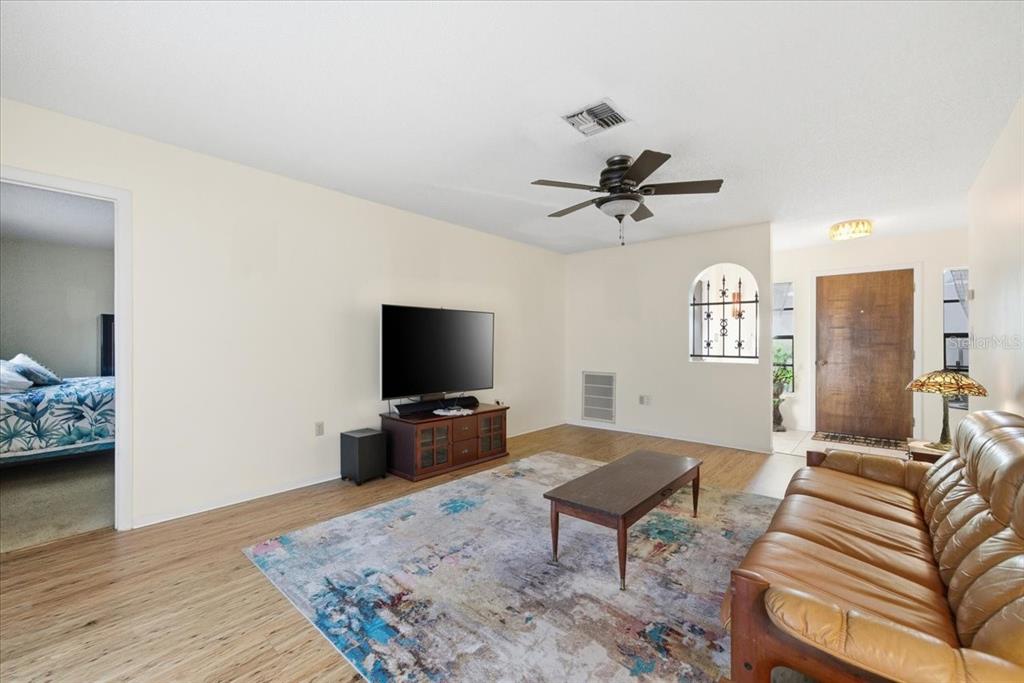 12439 Hanley Drive Spring Hill, FL 34608 - Photo 6 of 36 a living room with furniture and a flat screen tv