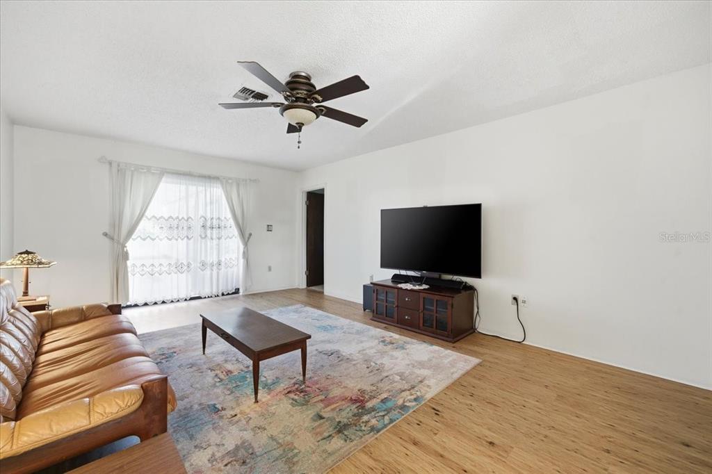 12439 Hanley Drive Spring Hill, FL 34608 - Photo 7 of 36 a living room with furniture and a flat screen tv