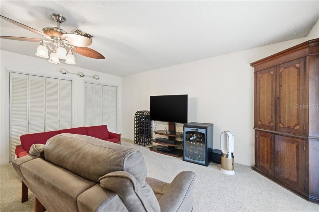 12439 Hanley Drive Spring Hill, FL 34608 - Photo 10 of 36 a bedroom with a bed and a television