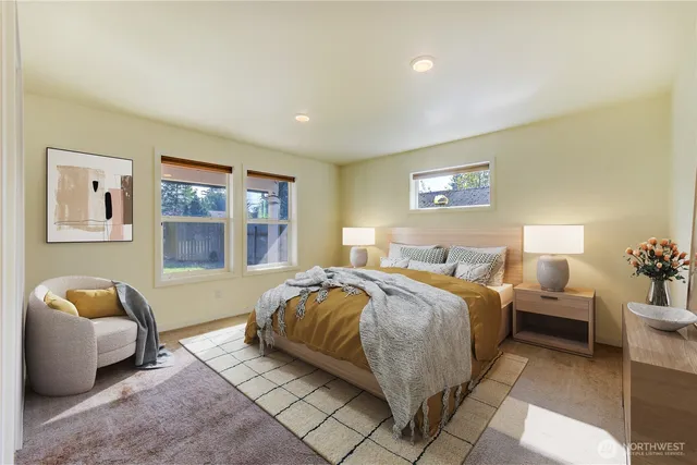 a spacious bedroom with a bed and couch