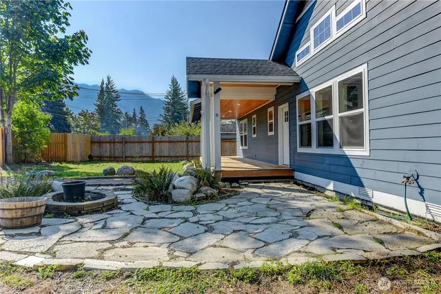 a view of house with backyard outdoor seating and plants