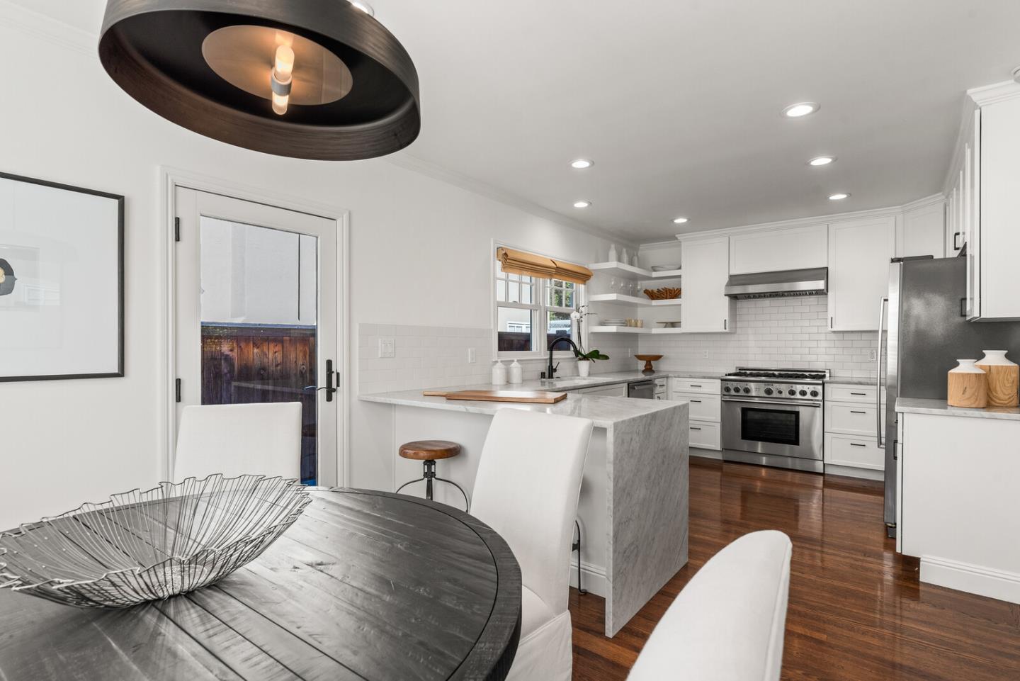 1350 Johnson Street Menlo Park, CA 94025 - Photo 9 of 30 a kitchen with a table chairs stove and cabinets