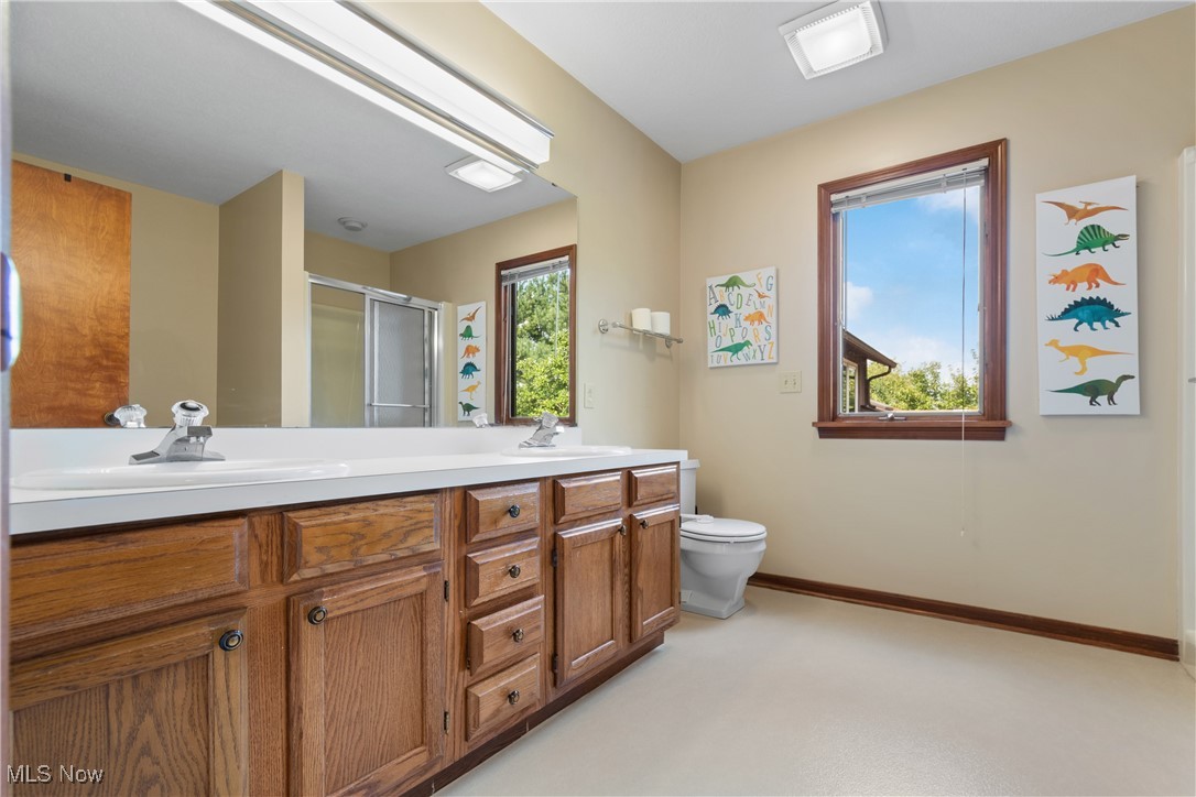 2317 Raintree Street Northeast Canton, OH 44705 - Photo 22 of 40 Full bathroom featuring a stall shower, healthy amount of natural light, and double vanity