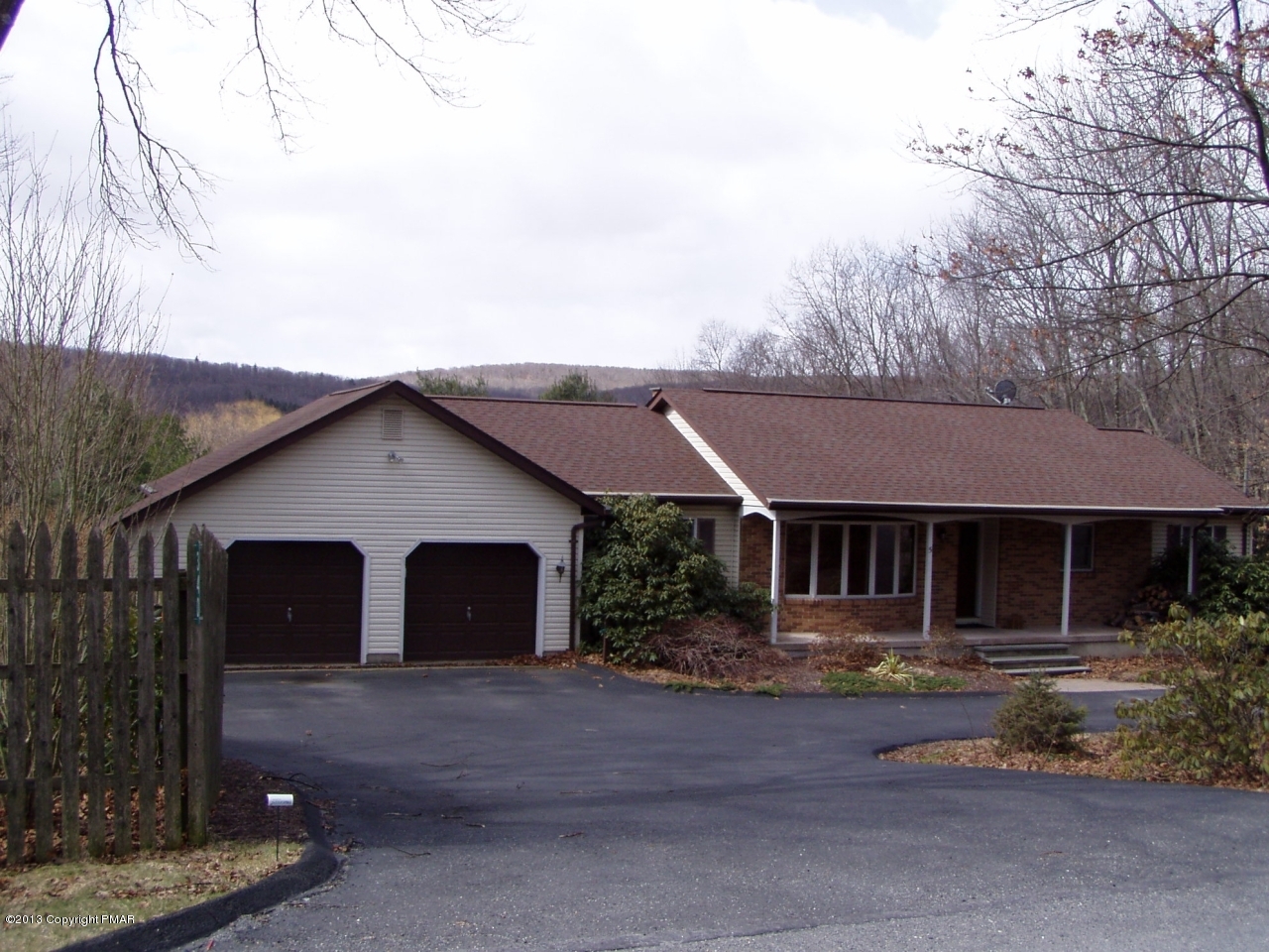 5 Orchard Road Swiftwater, PA 18370 - Photo 4 of 26 a front view of a house with a yard and garage