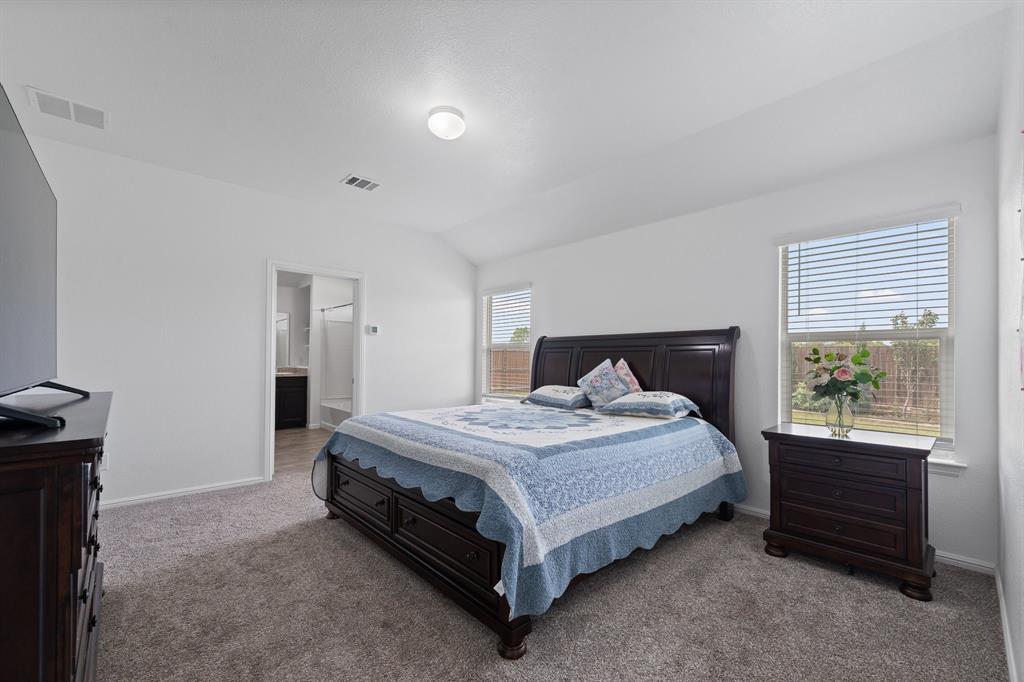 4600 Fringetree Way Crowley, TX 76036 - Photo 19 of 40 Carpeted room featuring white walls, a vaulted ceiling, and two windows with horizontal blinds
