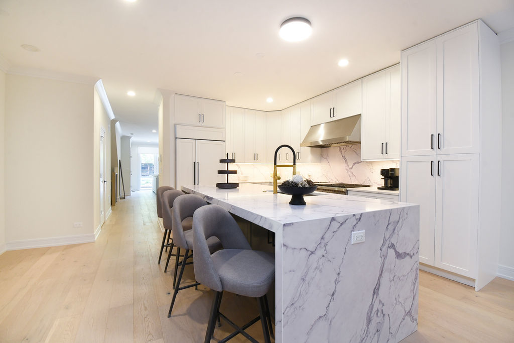 Undisclosed Address Chicago, IL 60613 - Photo 11 of 50 a kitchen with kitchen island granite countertop a sink and cabinets
