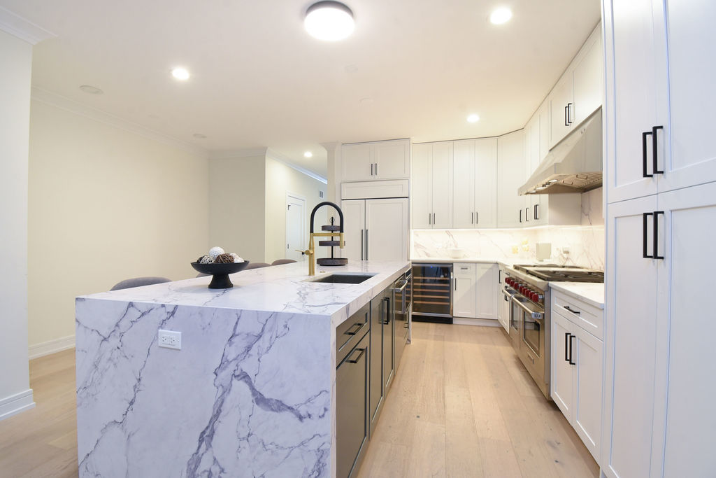 Undisclosed Address Chicago, IL 60613 - Photo 12 of 50 a kitchen with stainless steel appliances granite countertop a sink stove and refrigerator