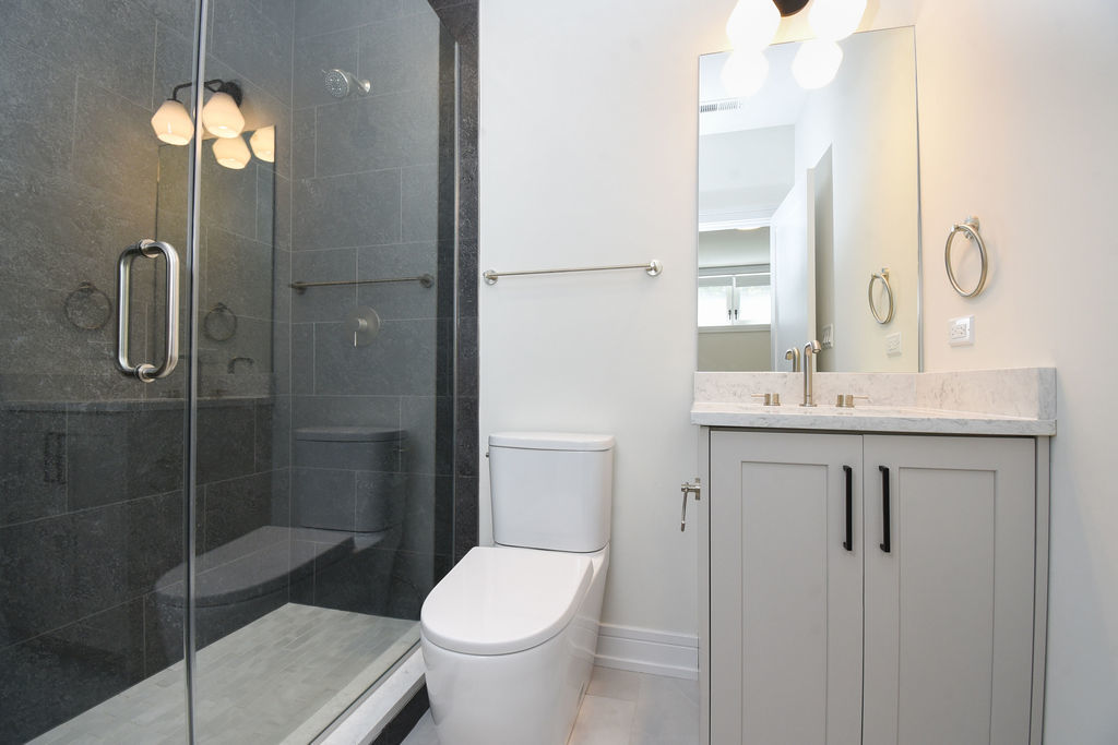 Undisclosed Address Chicago, IL 60613 - Photo 25 of 50 a bathroom with a sink a toilet and shower