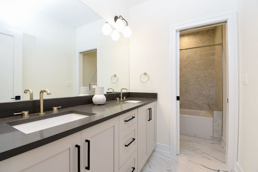 Undisclosed Address Chicago, IL 60613 - Photo 27 of 50 a bathroom with a double vanity sink and mirror