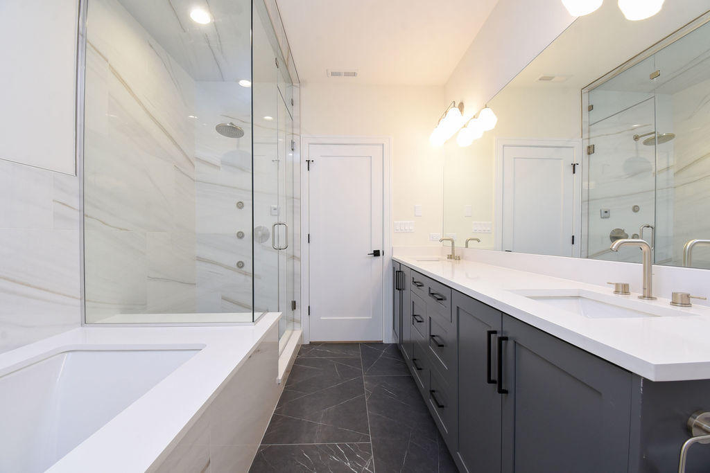 Undisclosed Address Chicago, IL 60613 - Photo 40 of 50 a spacious bathroom with a tub sink mirror and a shower