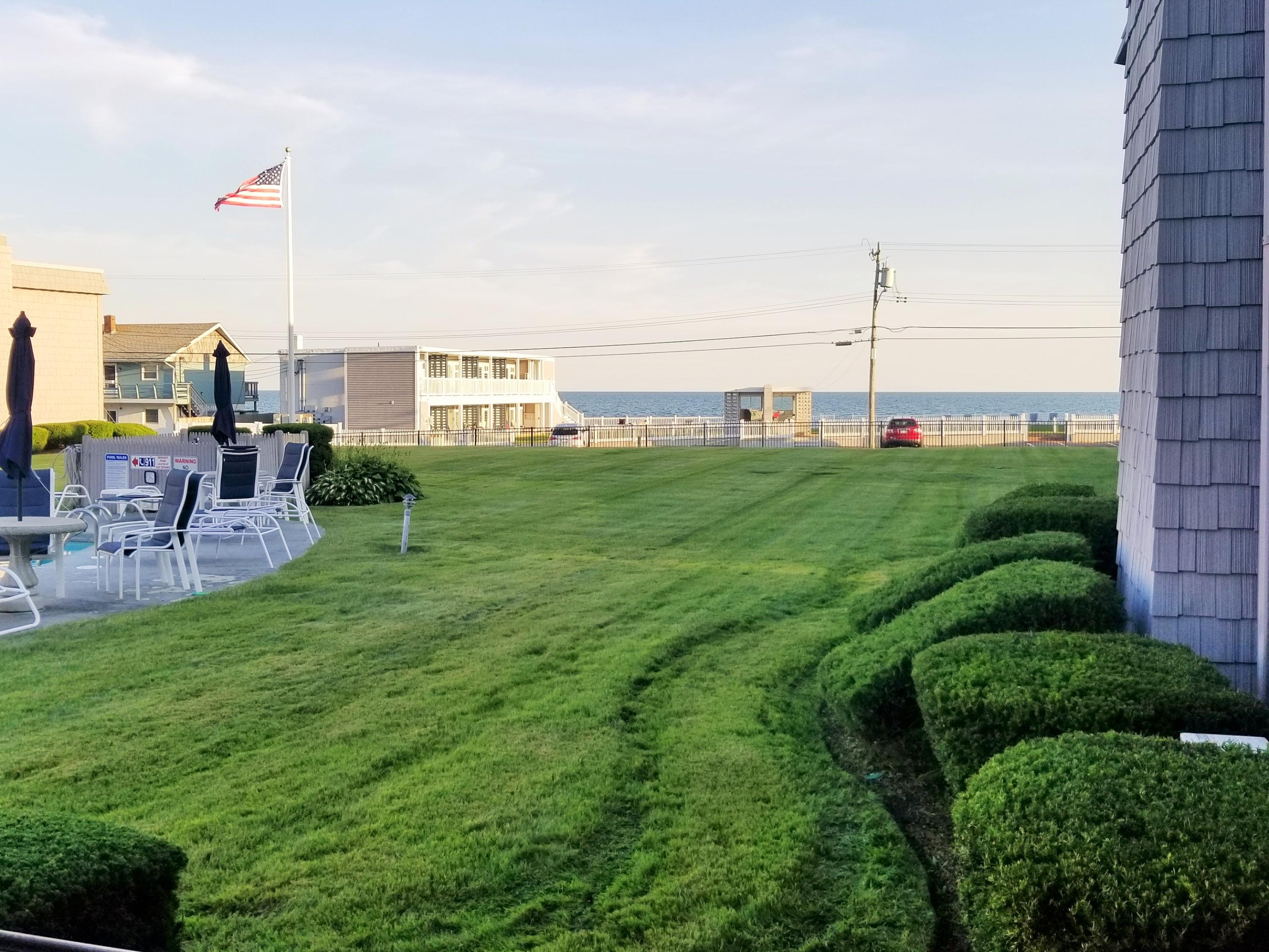 112 Old Wharf Road, Unit W9 Dennis Port, MA 02639 - Photo 13 of 19 a view of a terrace with a garden and chairs