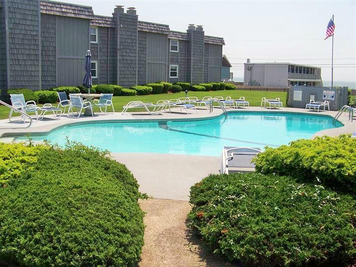 112 Old Wharf Road, Unit W9 Dennis Port, MA 02639 - Photo 15 of 19 a view of a swimming pool with a lawn chairs