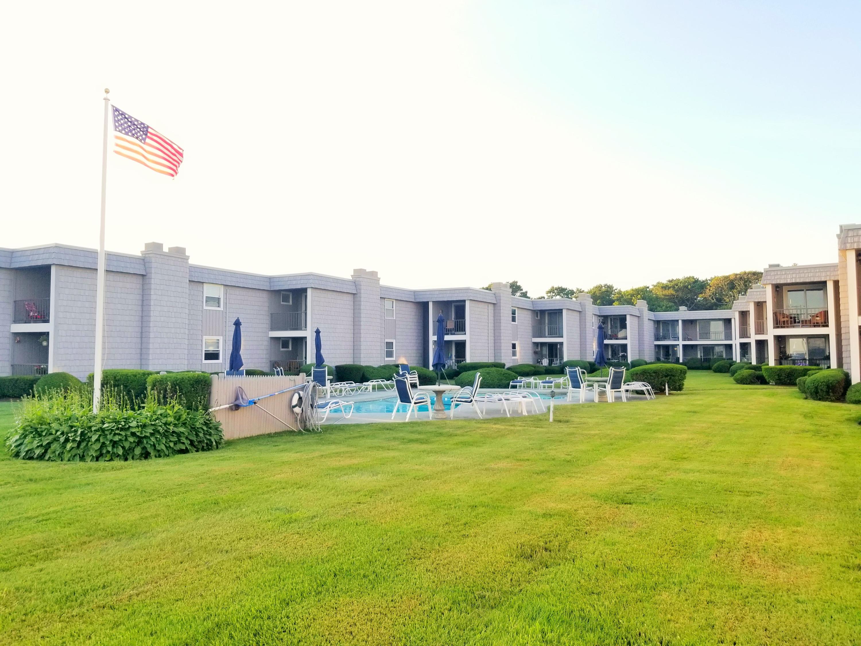 112 Old Wharf Road, Unit W9 Dennis Port, MA 02639 - Photo 16 of 19 a view of a building with a yard