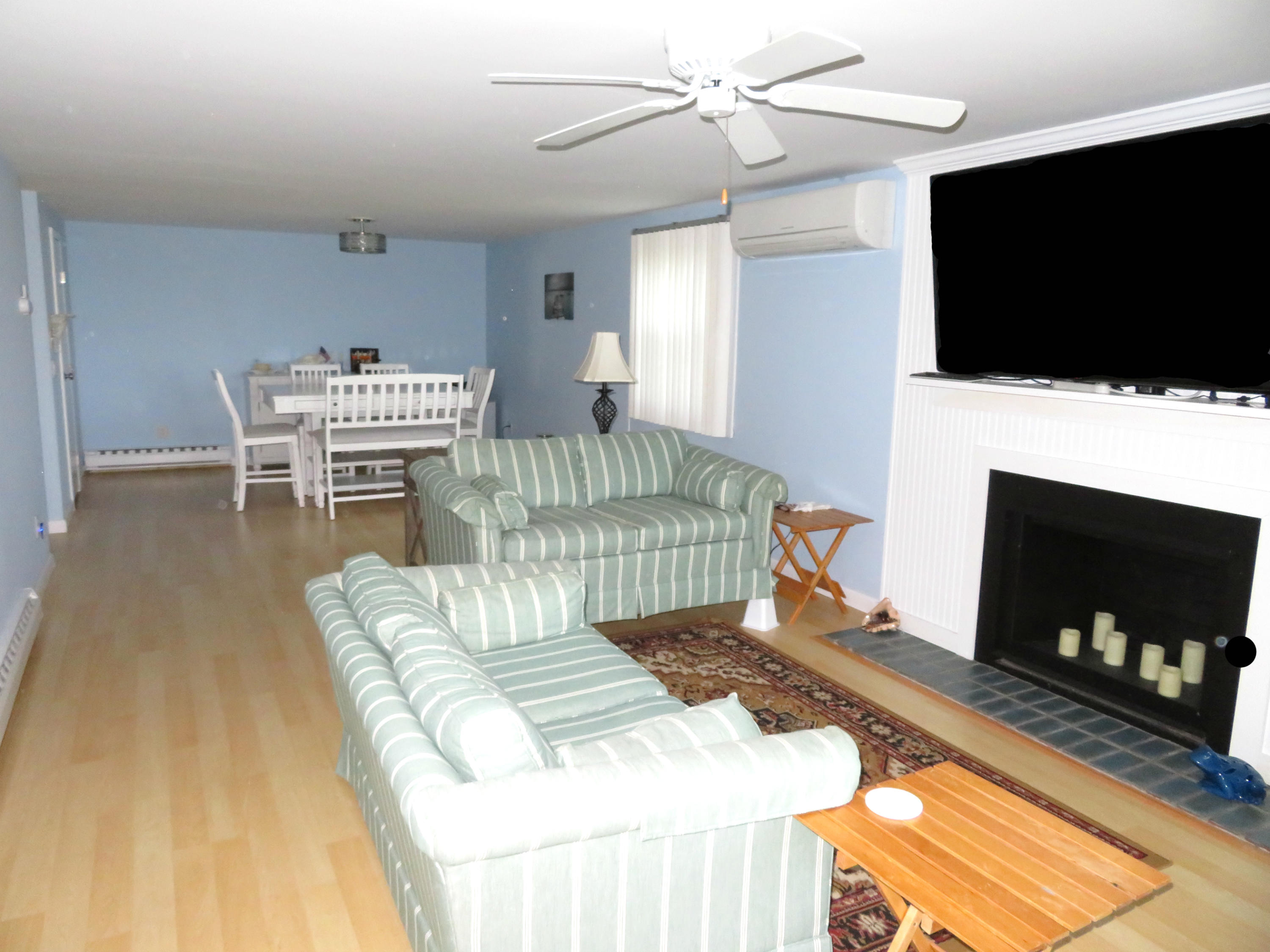 112 Old Wharf Road, Unit W9 Dennis Port, MA 02639 - Photo 3 of 19 a living room with a flat screen tv and a fireplace