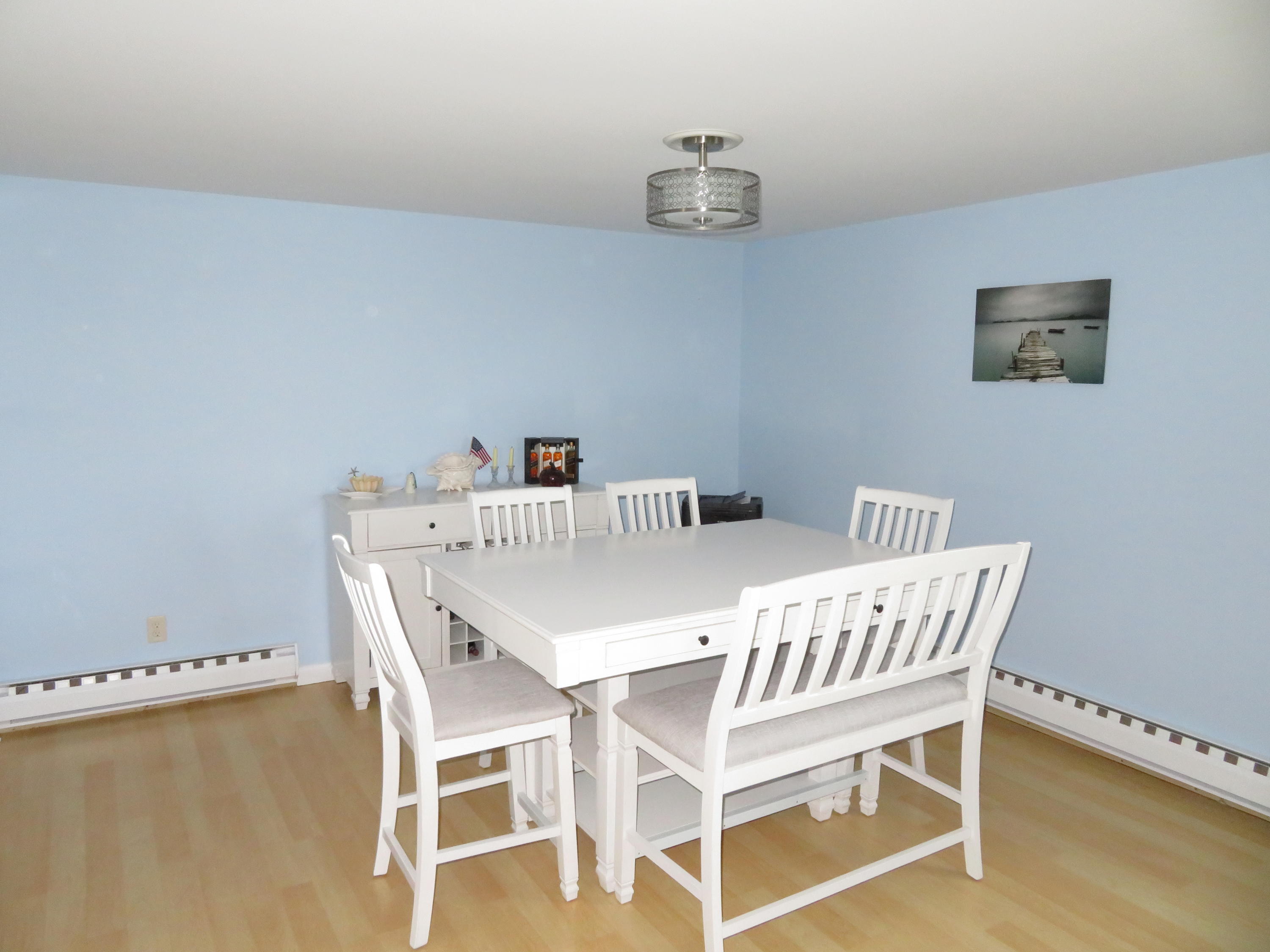 112 Old Wharf Road, Unit W9 Dennis Port, MA 02639 - Photo 4 of 19 a view of a dining room with furniture and wooden floor