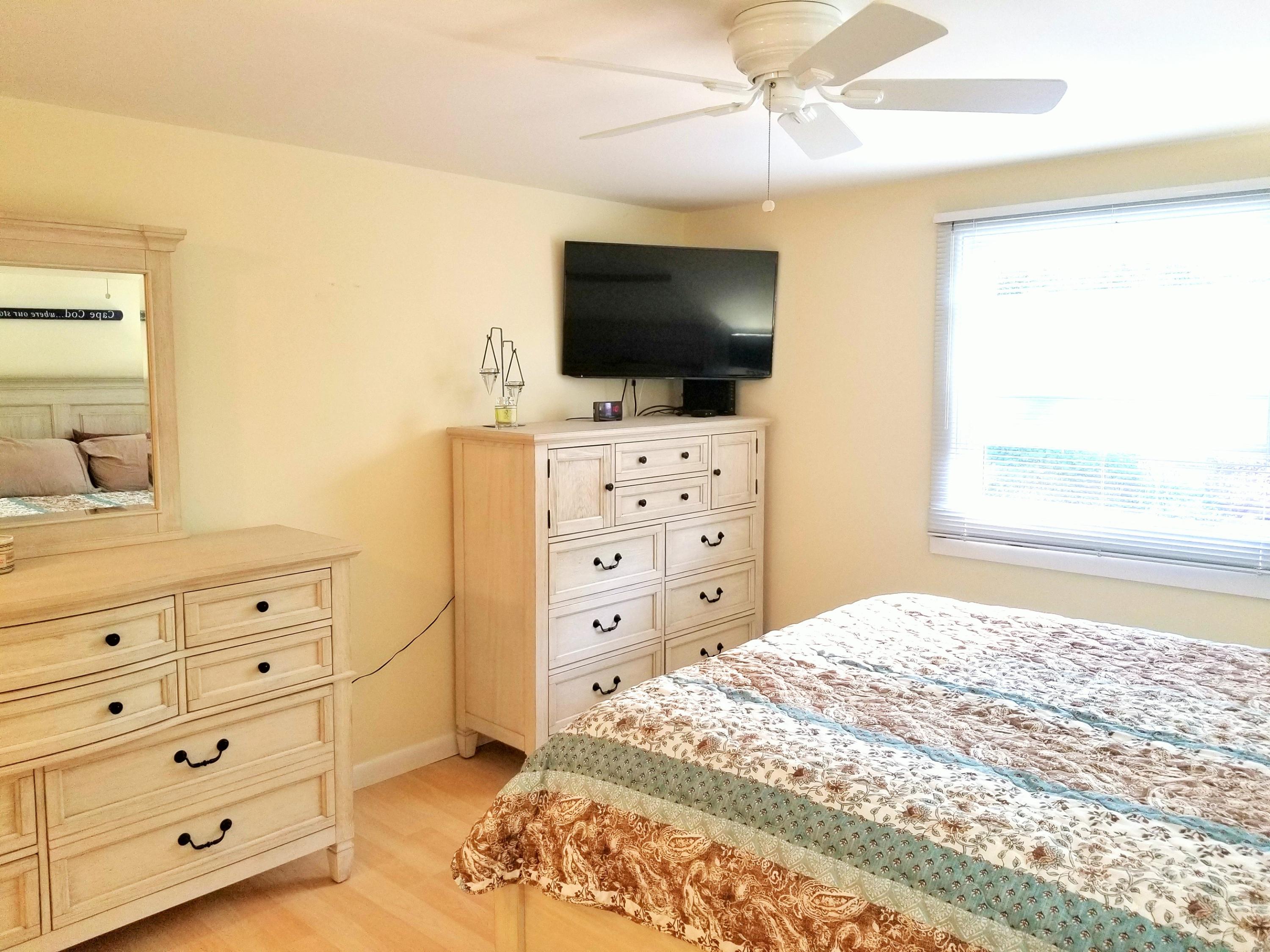 112 Old Wharf Road, Unit W9 Dennis Port, MA 02639 - Photo 5 of 19 a bedroom with a bed and a flat screen tv